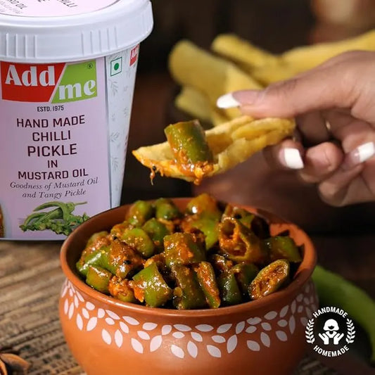 Handmade Chilli Pickle in Mustard Oil with a container labeled 'Add me' and a hand dipping a chip into the pickle.