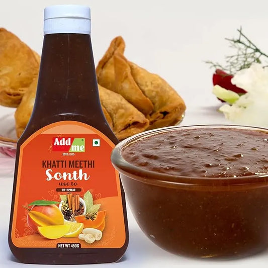 Bottle of Addsome Khatti Meethi Sonth with a bowl of the product and snacks in the background.