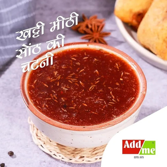 Spicy red chutney in a white bowl with text and Add Me logo.