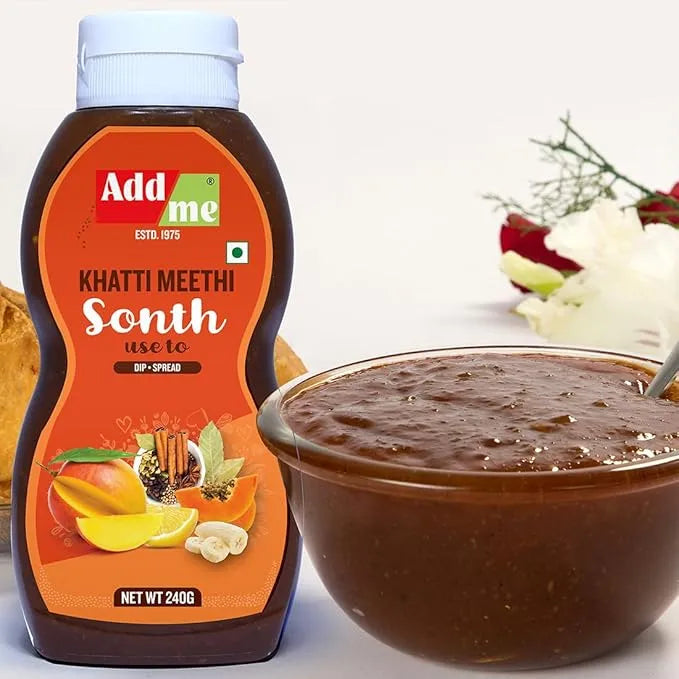 Bottle of Add Me Khatti Meethi Sonth with a bowl of the spread on a white background