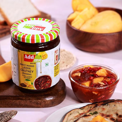 Jar of Add Me Sweet Mango Jeera Chutney with a bowl of chutney and bread slices on a table.