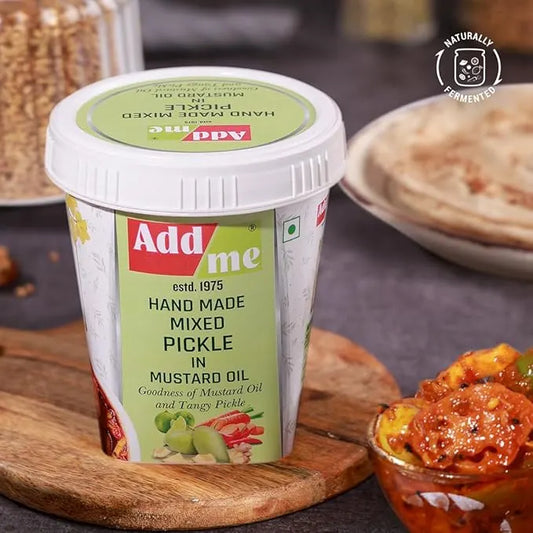 Container of Add Me hand made mixed pickle with mustard oil on a wooden board. mix achar
