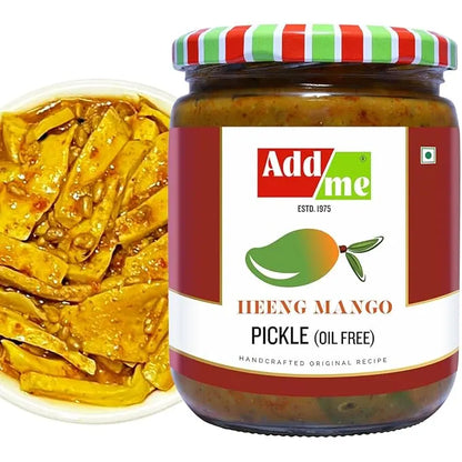Jar of Add Me Heeng Mango Pickle with a close-up of pickles on a white plate.