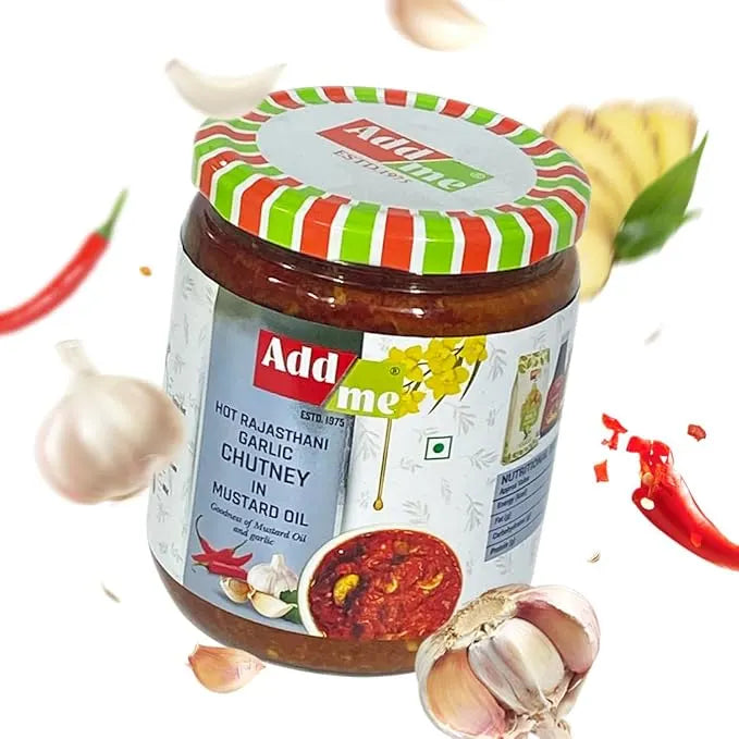 Jar of Adda me Hot Rajasthani Garlic Chutney with garlic and red chili peppers on a white background