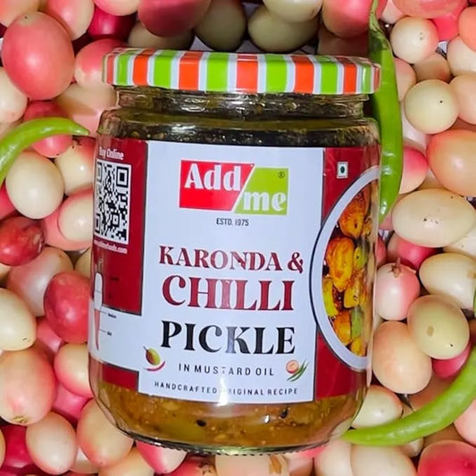 Jar of Add Me Karonda & Chilli Pickle surrounded by ingredients