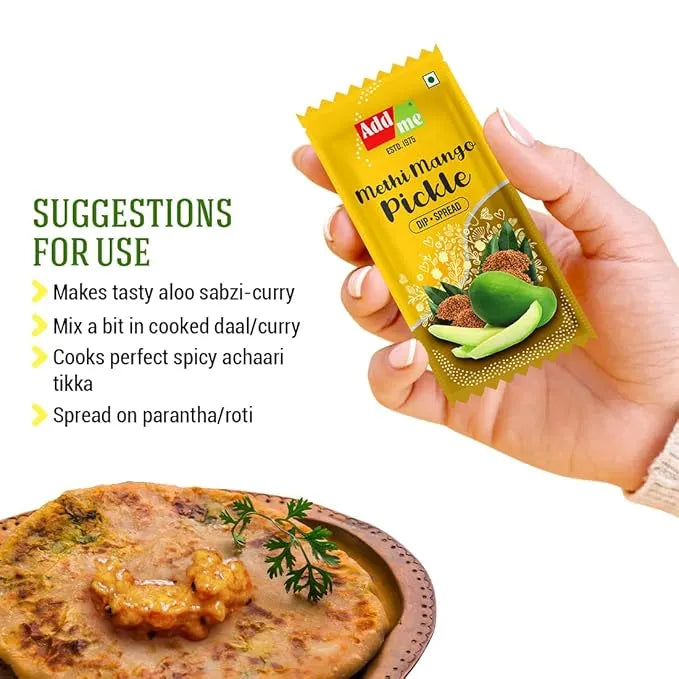 Add Me Foods: Hand holding a yellow packet of Methi Mango Pickle with suggestions for use on a white background