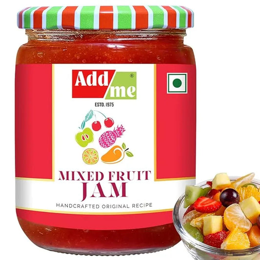 Add Me Foods: Jar of Add Me mixed fruit jam with a colorful lid and a bowl of fruit salad on a white background.