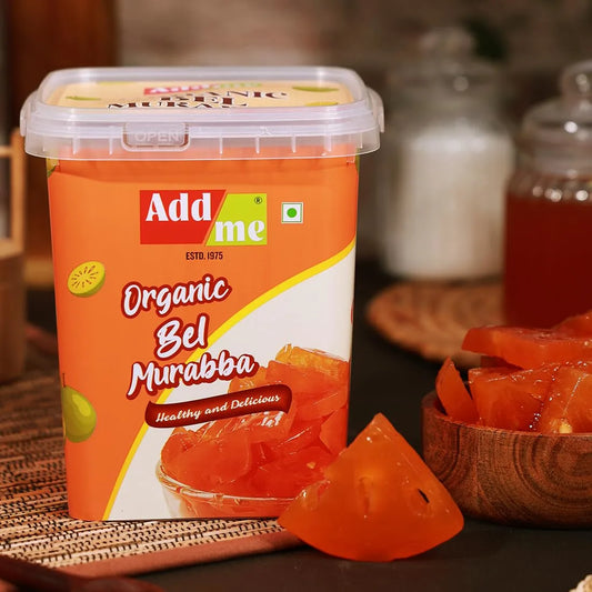 Container of Add Me Organic Bel Murabba with a bowl of fruit in the background