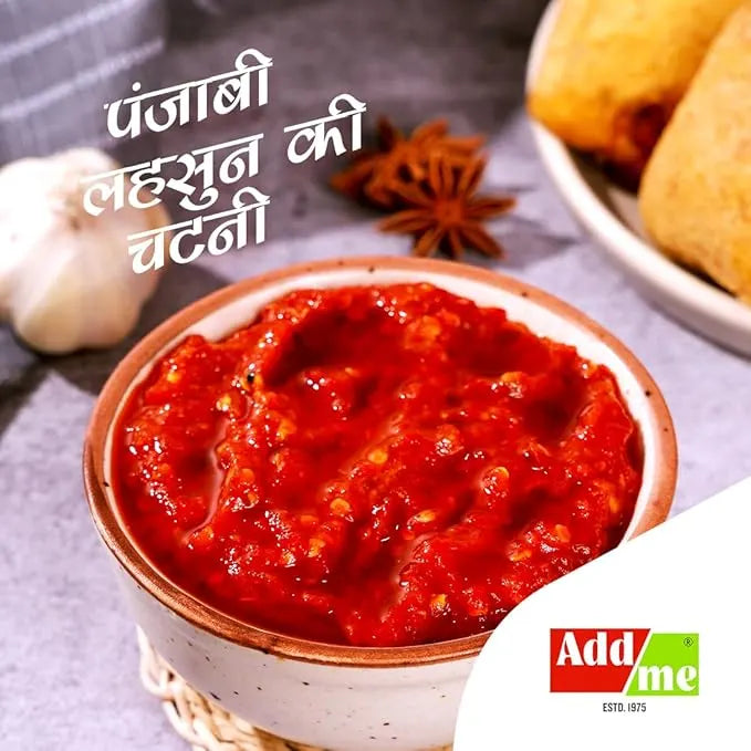 Bowl of red chutney with text and Add Me logo on a gray background