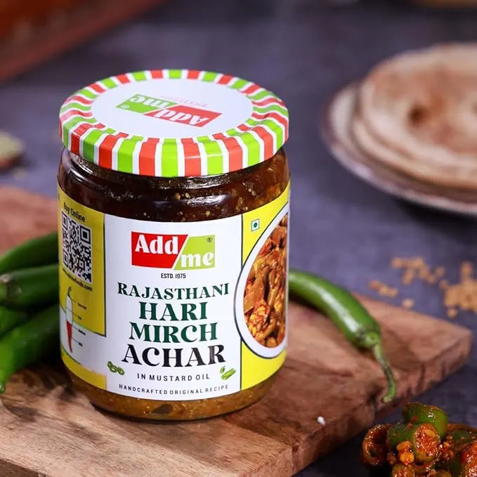 Add Me Foods: Jar of Add Me Rajasthani Hari Mirch Achar on a wooden board with green chilies.