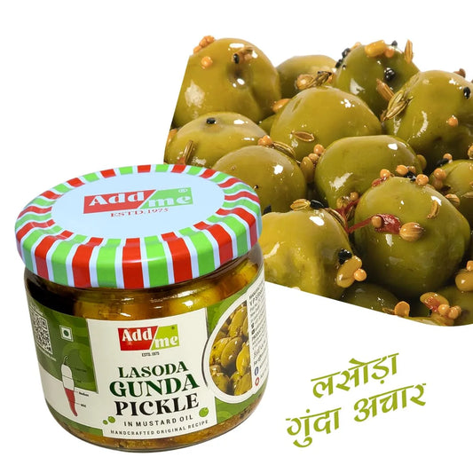 Jar of Addme Lasoda Gunda Pickle with green olives in the background