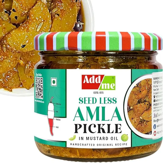 Jar of AddaMe Seed Less Amla Pickle with a striped lid, displayed with a plate of pickled vegetables.